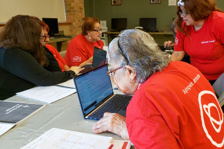 seniors learning to use computers and software in technology course for people over age 60