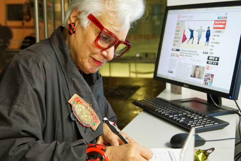 Senior woman learning new computer skills through a course for seniors in New York City