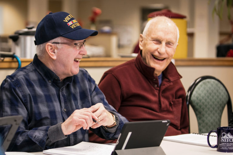 men taking computer technology class for seniors