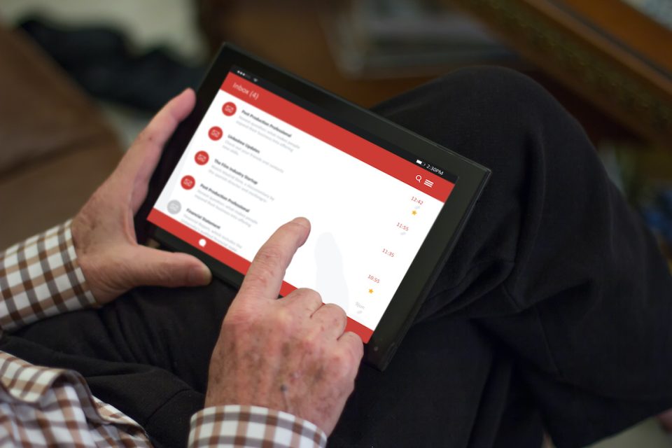 older man checking email on tablet