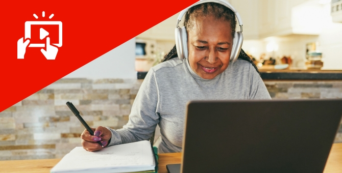 senior woman working on computer taking notes