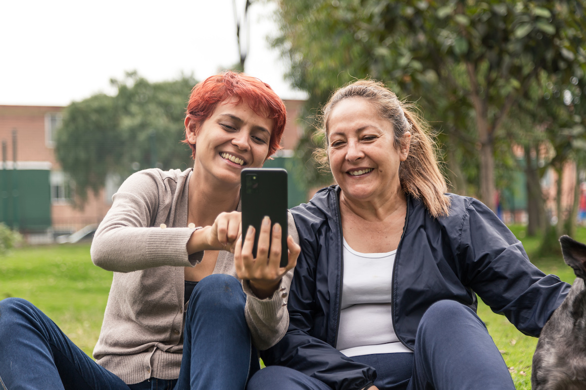 mother and daughter taking selfie in the park