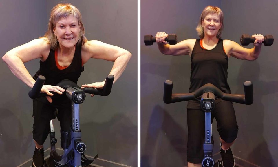senior woman riding on spin bike and lifting weights
