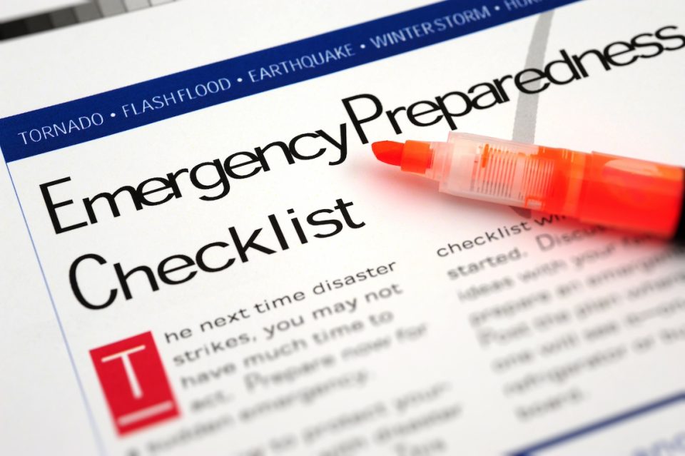 close up of emergency preparedness checklist document and highlighter pen
