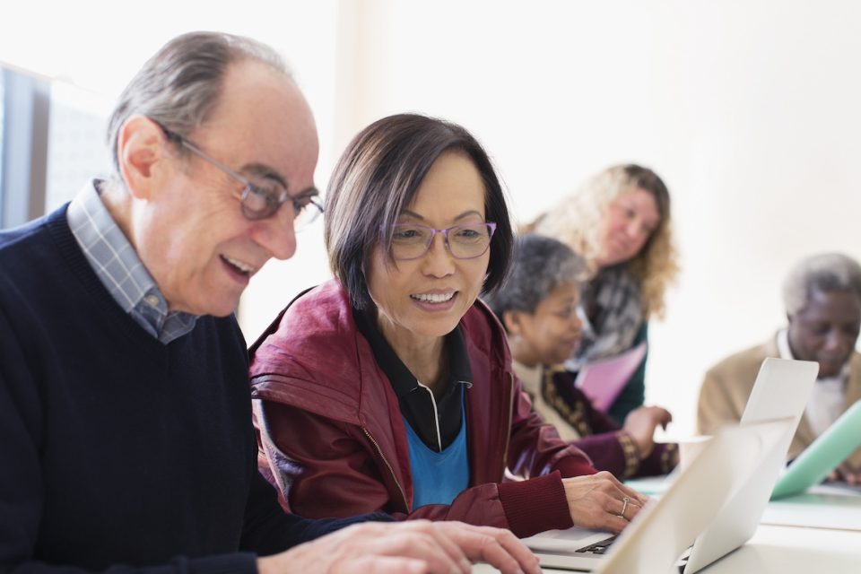 Senior business people using laptop in conference room meeting investment club