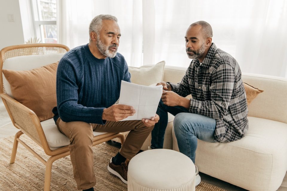senior man talking to adult son about finances