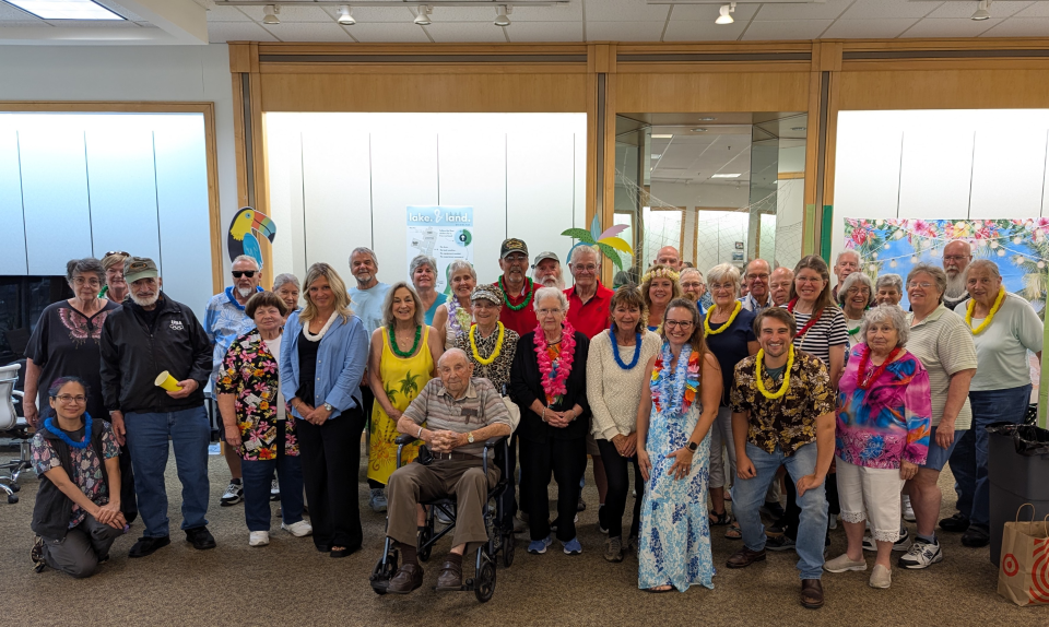 Group of people sit at a table during an event.