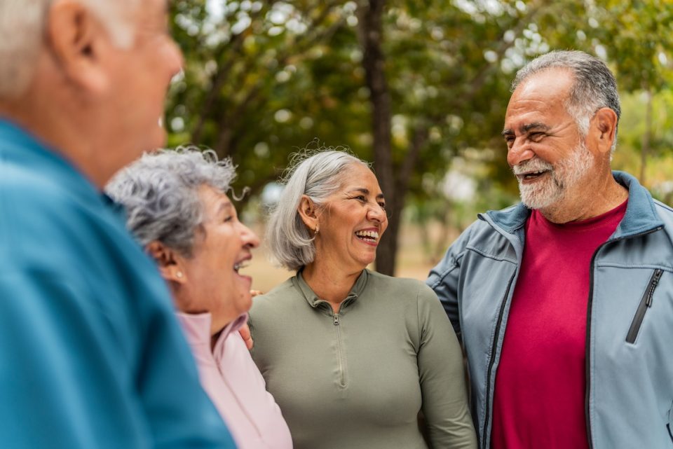 Senior friends talking on public park