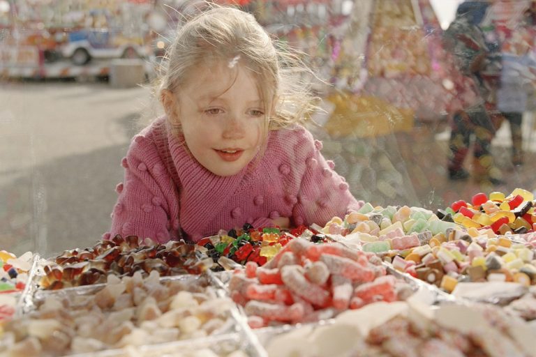 Girl looking at sweets in glass counter