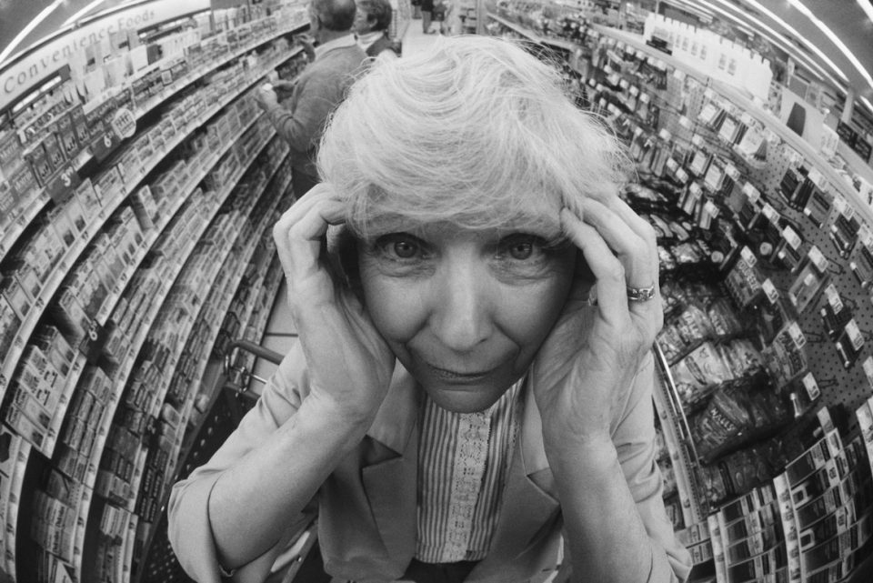 Stressed Senior Woman Shopping in Drugstore